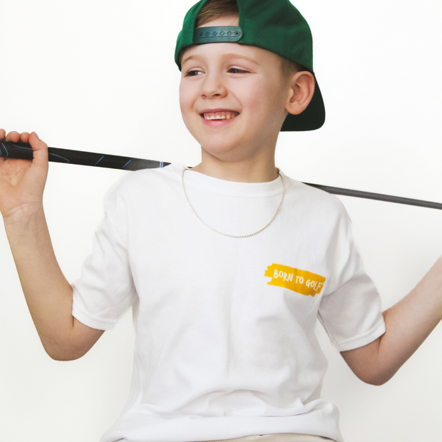 Child wearing a white t-shirt with a logo and a green cap, sitting on a white background