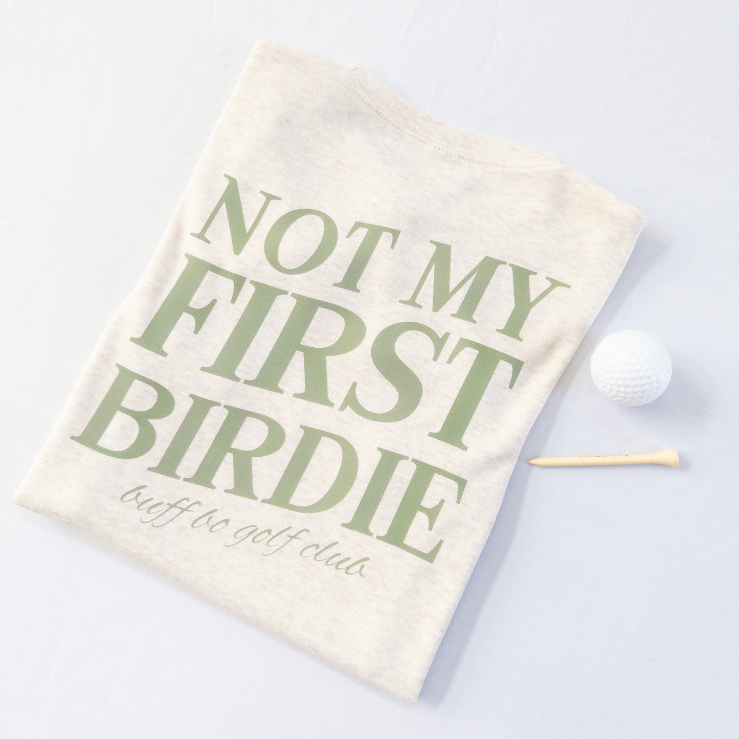 Golf towel with 'Not My First Birdie' text on a light background