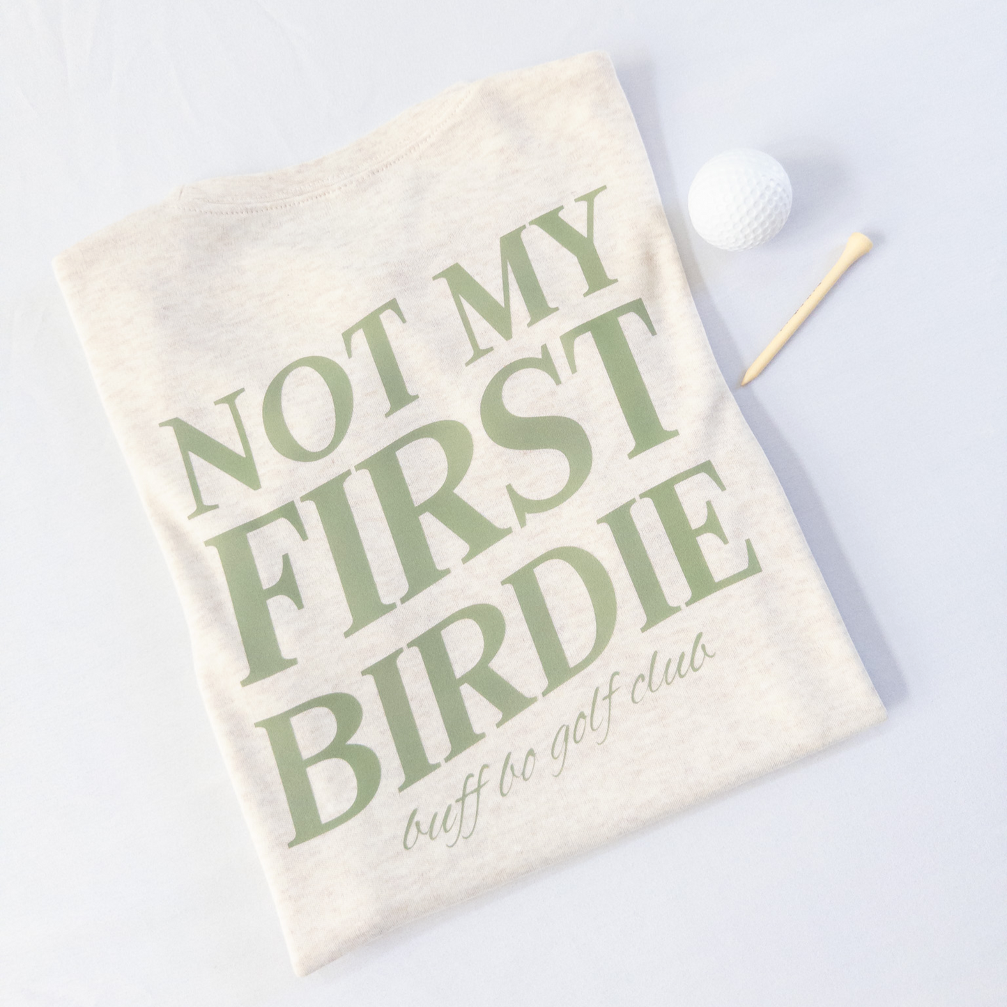 Golf towel with 'Not My First Birdie' text on a white background