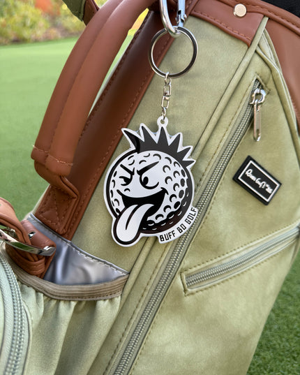 Keychain with a logo attached to a golf bag