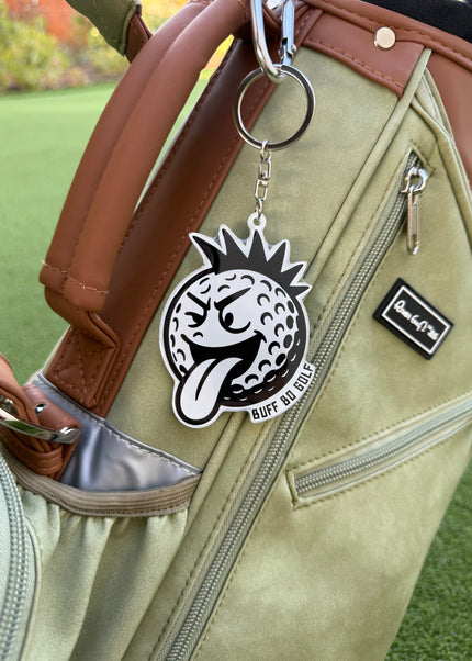 Keychain with a logo attached to a golf bag