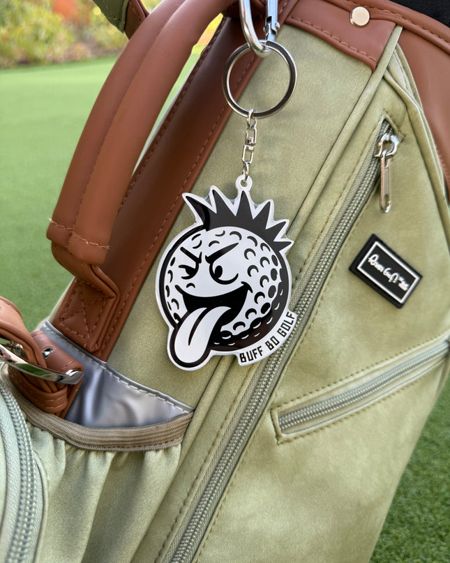 Keychain with a logo attached to a golf bag