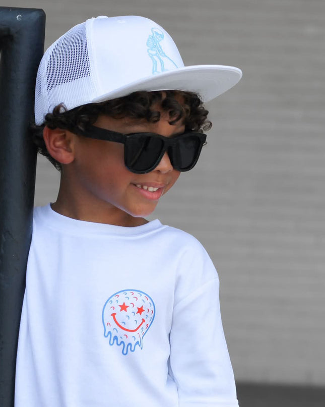 Child wearing a white cap and sunglasses with a plain background