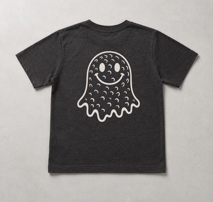 A dark charcoal gray short-sleeve t-shirt with a white graphic of a cute, smiling ghost on the front, laid flat against a light gray textured background.