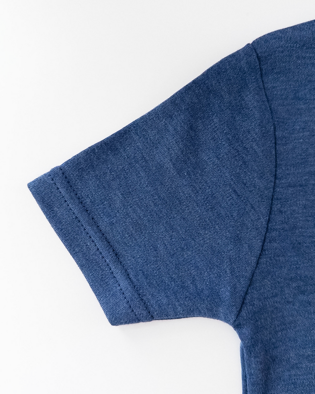 Close-up of a blue t-shirt sleeve on a white background