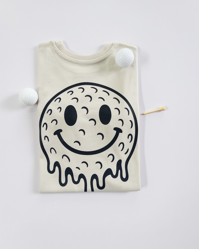 Beige t-shirt with a black smiley face design on a white background