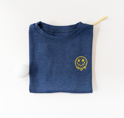 Folded blue shirt with a yellow smiley face design on a white background
