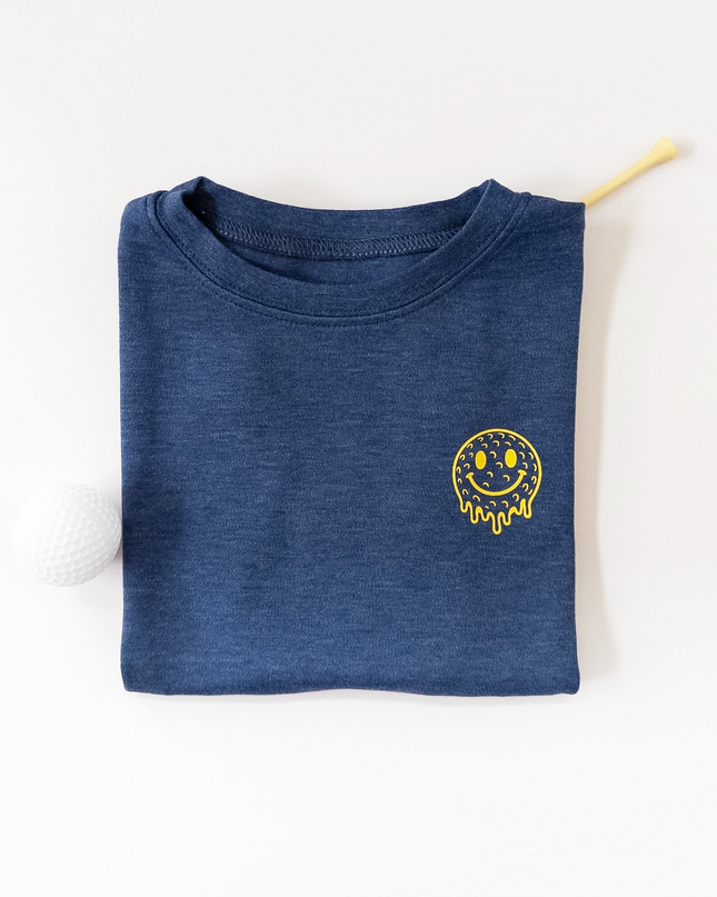 Folded blue shirt with a yellow smiley face design on a white background