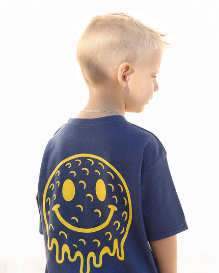 Child wearing a blue t-shirt with a yellow smiley face design on the back, against a white background