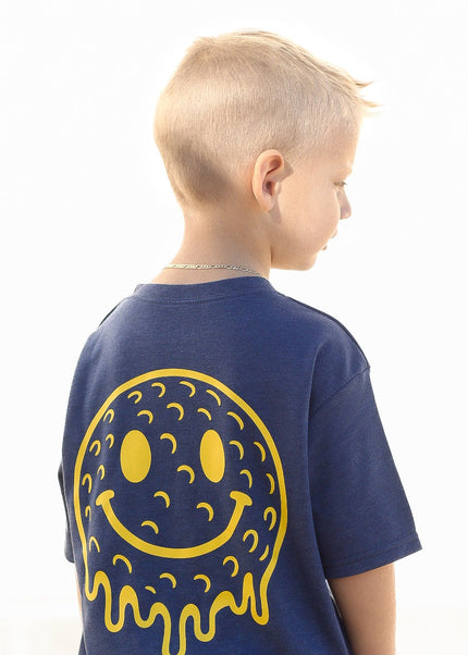 Child wearing a blue t-shirt with a yellow smiley face design on the back, against a white background