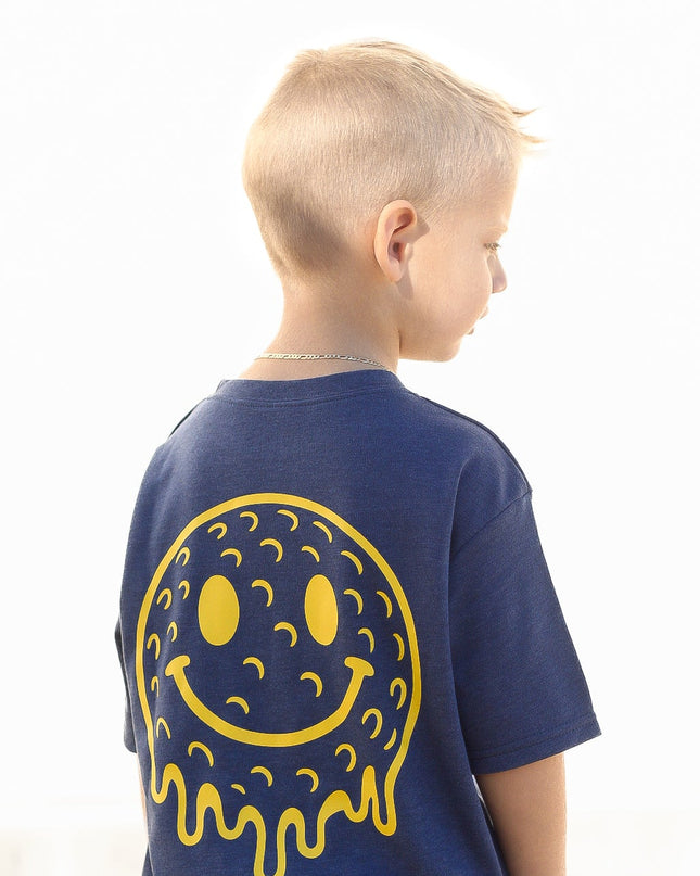 Child wearing a blue t-shirt with a yellow smiley face design on the back, against a white background