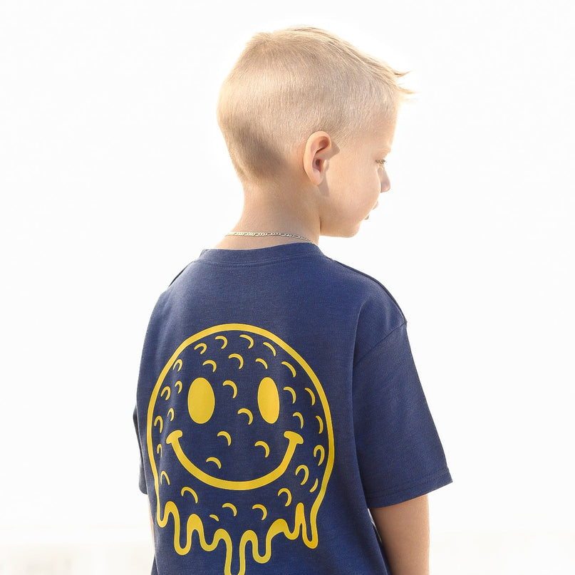 Child wearing a blue t-shirt with a yellow smiley face design on the back, against a white background