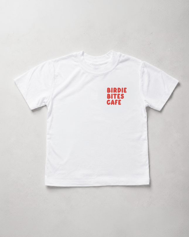 A white short-sleeve crewneck t-shirt with 'BIRDIE BITES CAFE' printed in red text on the left chest, laid flat on a light gray background.
