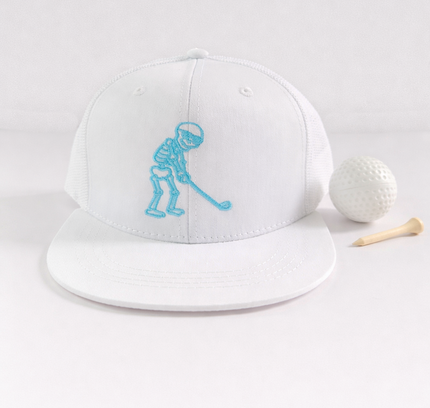 White cap with blue graphic, golf ball, and tee on a light gray background