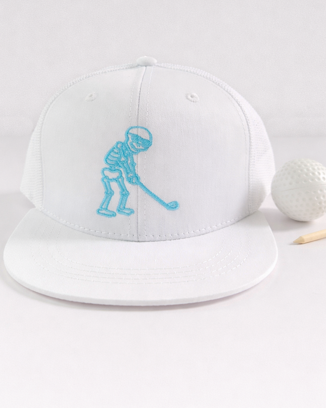 White cap with blue graphic, golf ball, and tee on a light gray background