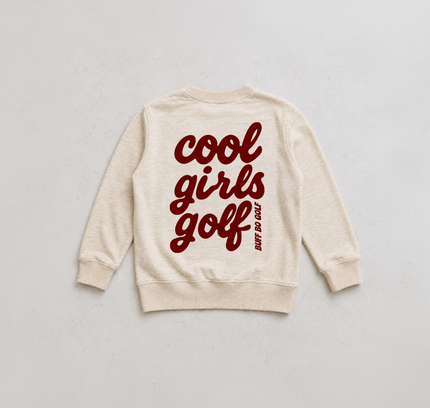An off-white crewneck sweatshirt with 'cool girls golf' printed in dark red script across the back, accompanied by a small vertical 'NOT DO GOLF' tagline, laid flat on a light gray background.