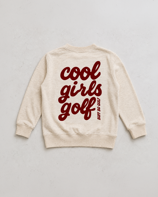 An off-white crewneck sweatshirt with 'cool girls golf' printed in dark red script across the back, accompanied by a small vertical 'NOT DO GOLF' tagline, laid flat on a light gray background.