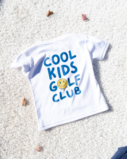 image of kids golf shirt in a bunker 