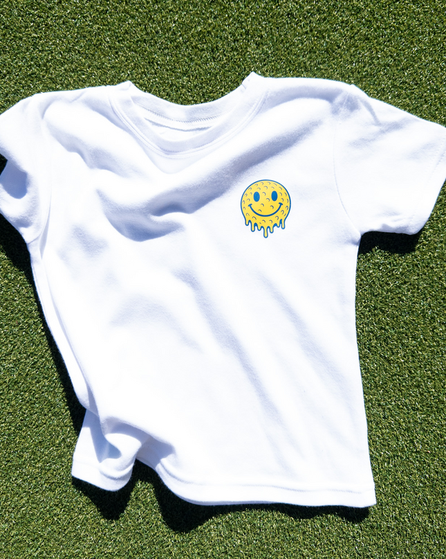 Image of kids golf shirt with melting golf face on the front of the shirt. 