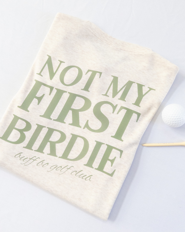 Golf towel with 'Not My First Birdie' text on a light background