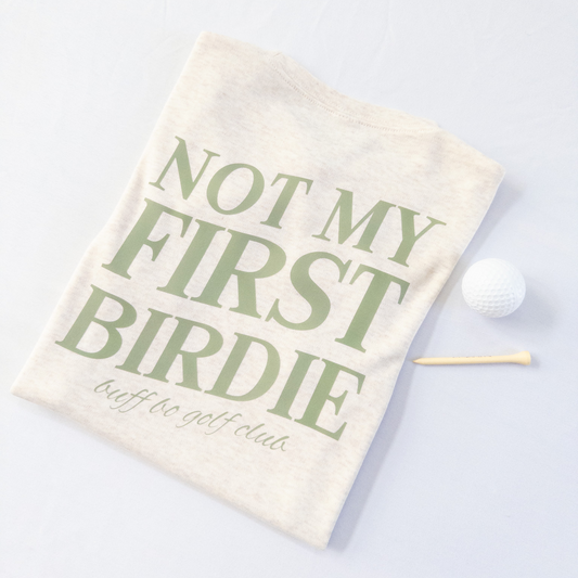 Golf towel with 'Not My First Birdie' text on a light background