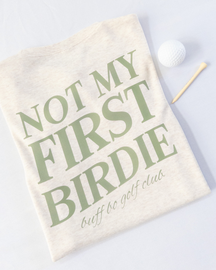 Golf towel with 'Not My First Birdie' text on a white background