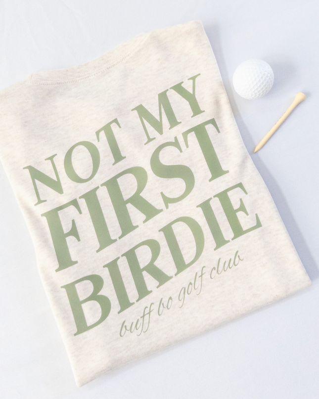 Golf towel with 'Not My First Birdie' text on a white background