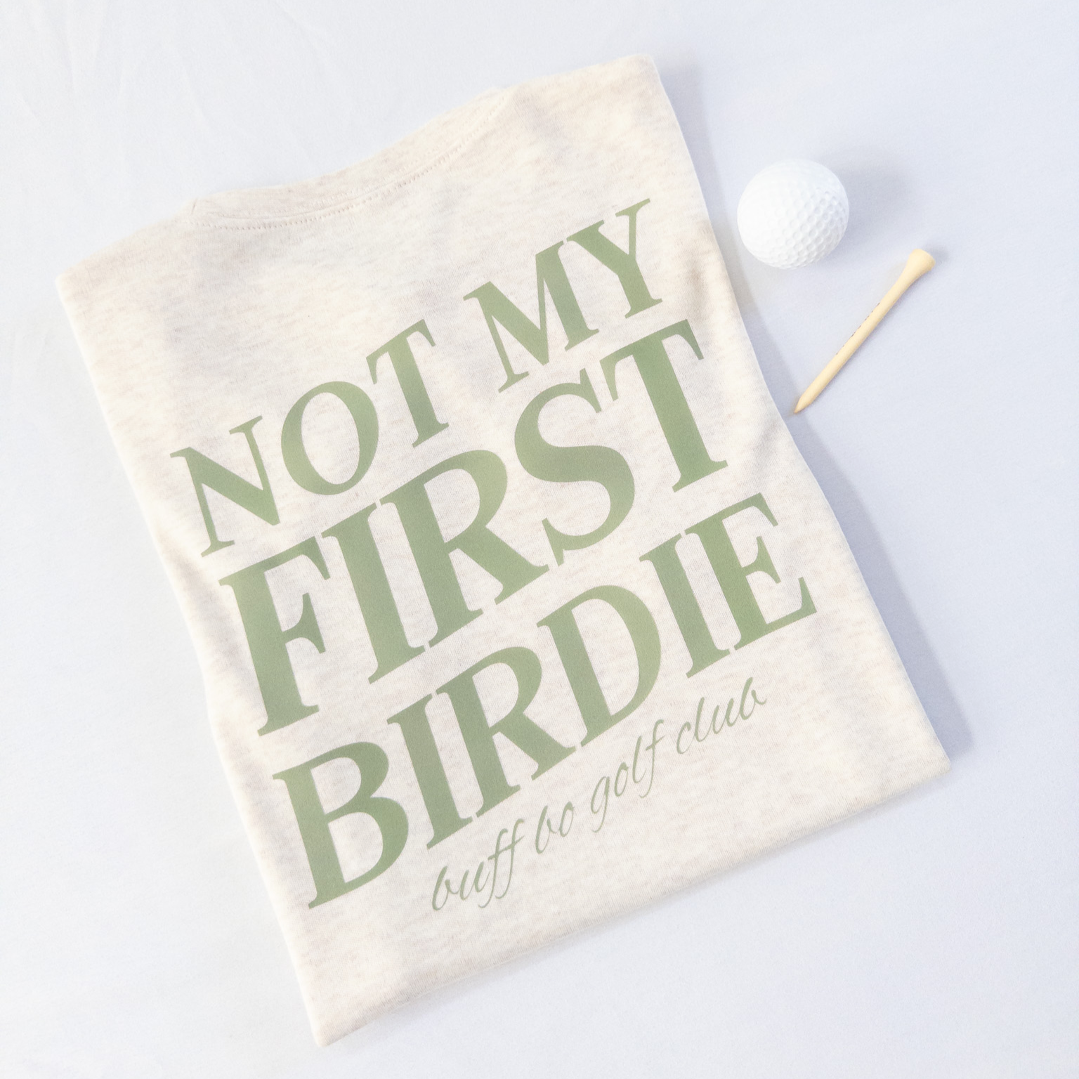 Golf towel with 'Not My First Birdie' text on a white background