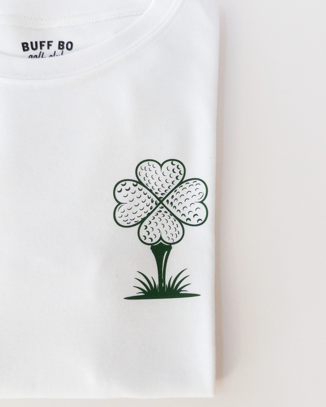 White t-shirt with a black and green clover design and text on a light gray background
