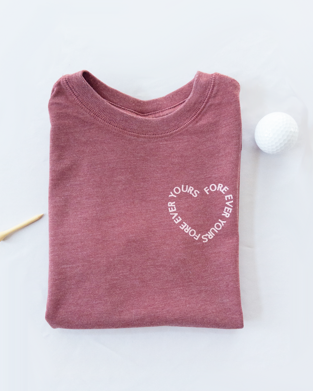 Folded maroon shirt with white text on a light gray background