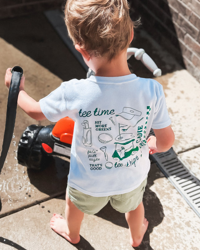 Child holding a garden hose on a patio
