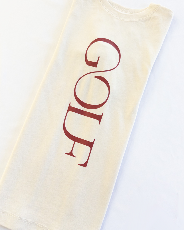 Beige shirt with 'GOLF' printed in red on a white background