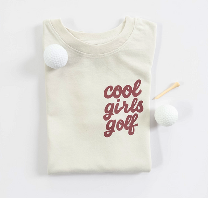 Beige t-shirt with 'cool girls golf' text on a white background