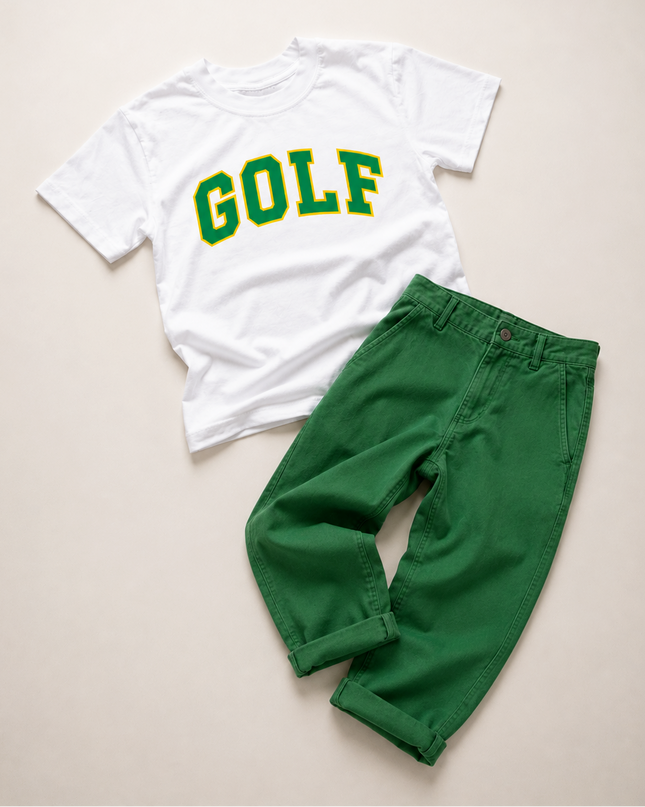 A children's two-piece outfit laid flat on a light beige background, featuring a white short-sleeve T-shirt with 'GOLF' printed in green and yellow varsity lettering, paired with bright green pants.