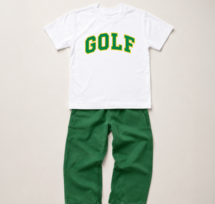 A kids' two-piece clothing set featuring a white short-sleeve t-shirt with 'GOLF' printed in green varsity letters, paired with solid green pants, laid flat on a light beige background.