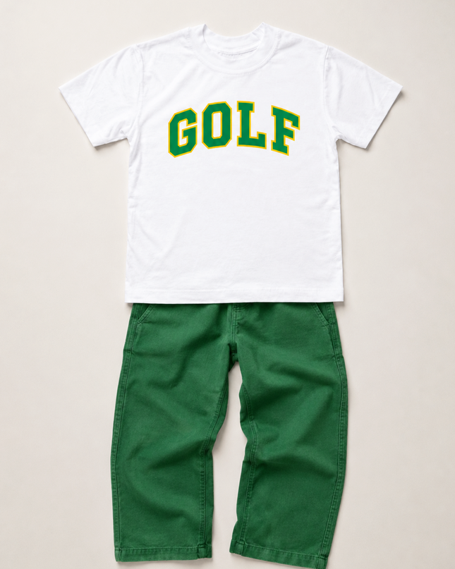 A kids' two-piece clothing set featuring a white short-sleeve t-shirt with 'GOLF' printed in green varsity letters, paired with solid green pants, laid flat on a light beige background.