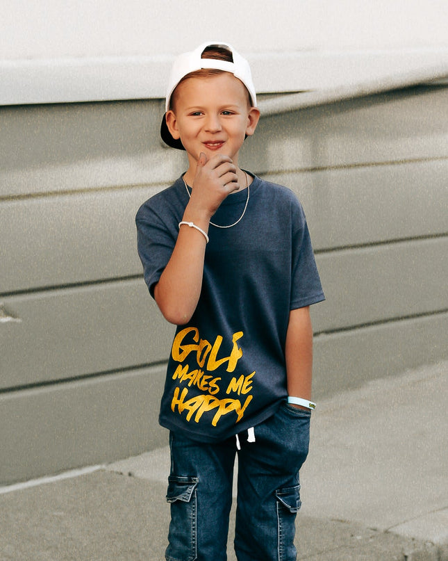 Child wearing a blue t-shirt with text and jeans standing on a sidewalk.