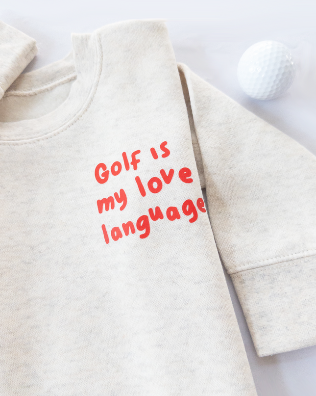Beige sweatshirt with 'Golf is my love language' text on a light background