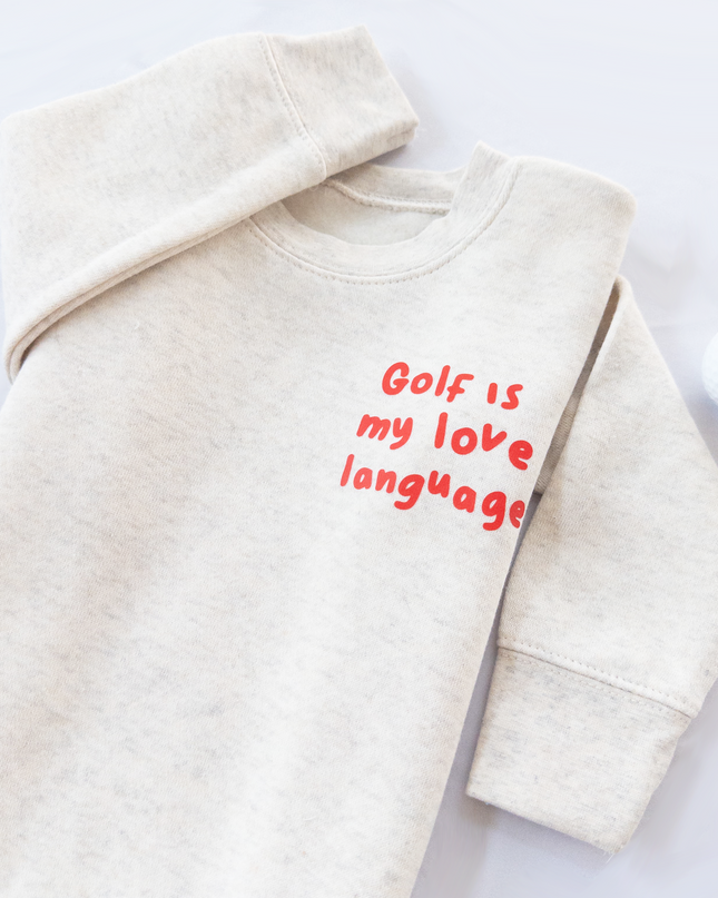 Beige sweatshirt with 'Golf is my love language' text on a white background