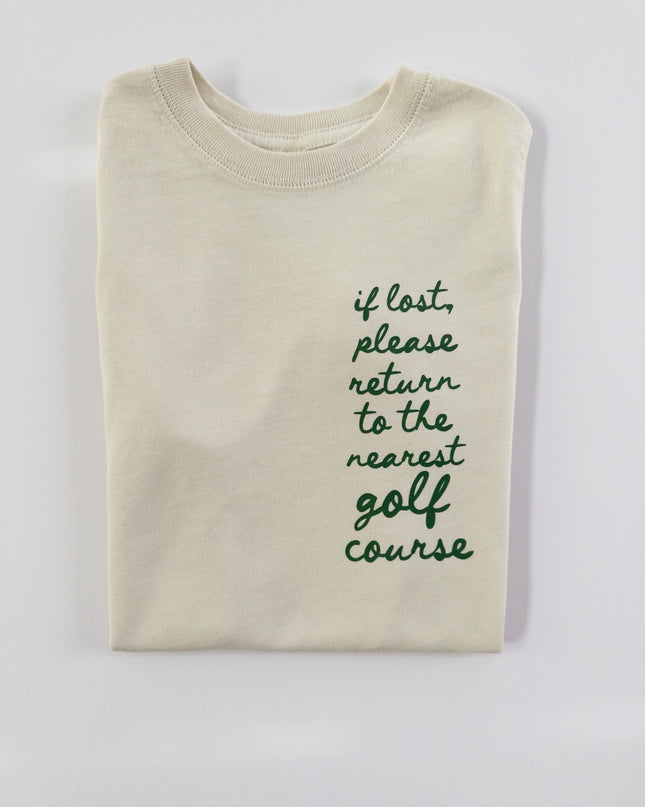 Beige sweatshirt with text 'if lost, please return to the nearest golf course' on a light gray background