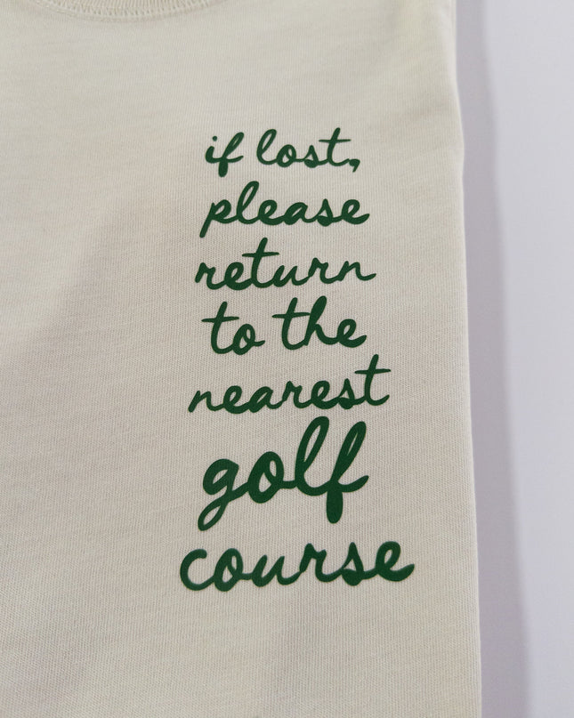 Beige sweatshirt with green text 'if lost, please return to the nearest golf course' on a white background