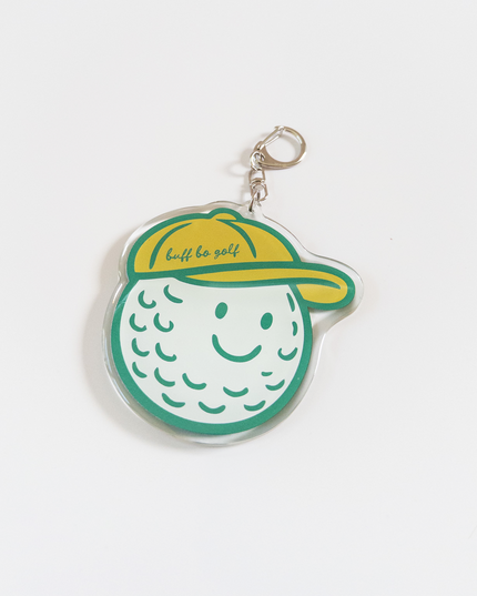 Keychain shaped like a golf ball with a yellow cap on a white background