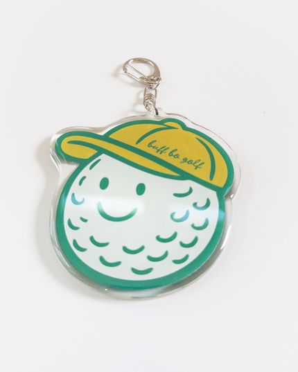 Keychain shaped like a golf ball with a yellow cap on a white background