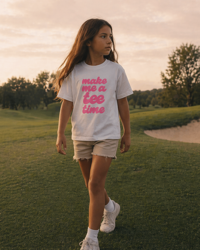 Girl walking on a golf course wearing a t-shirt with text