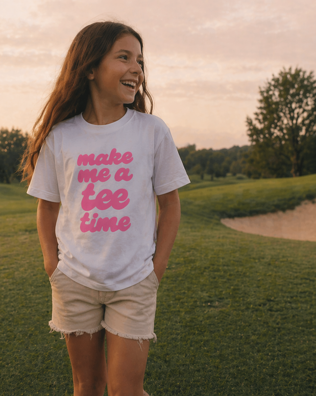 Girl wearing a t-shirt with text on a golf course at sunset