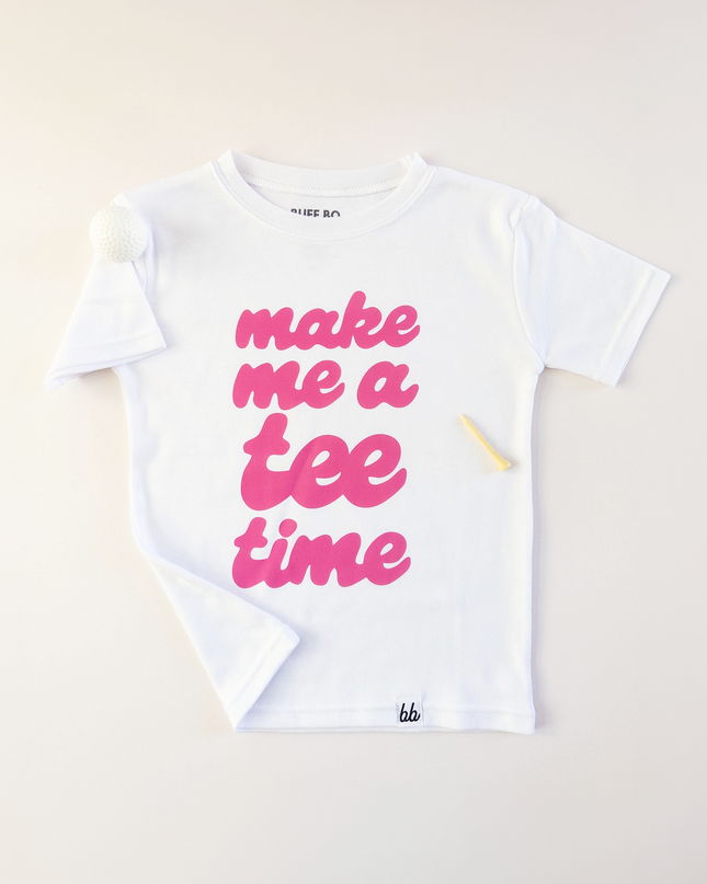 White t-shirt with pink text 'make me a tee time' on a light background