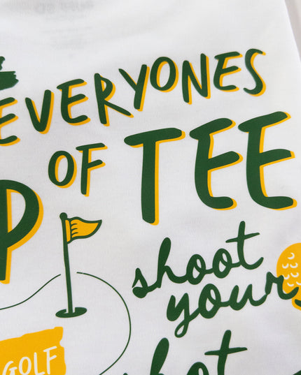 White t-shirt with green and yellow text and graphics on a white background