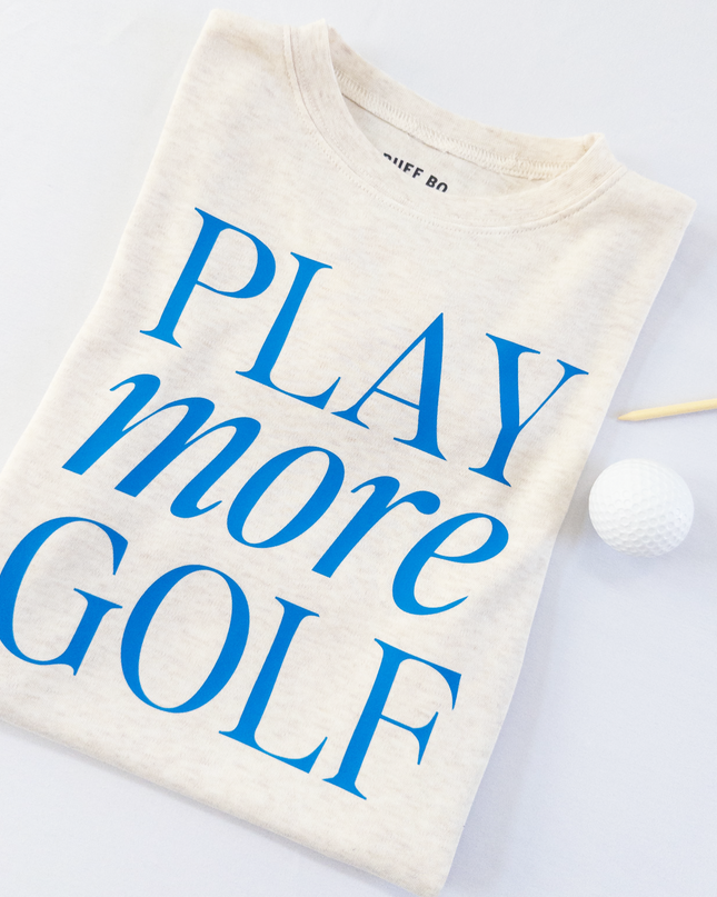 Folded t-shirt with 'PLAY more GOLF' text on a white background