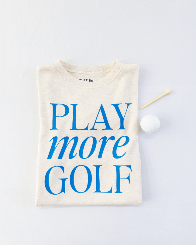 Beige t-shirt with 'PLAY more GOLF' text on a light gray background