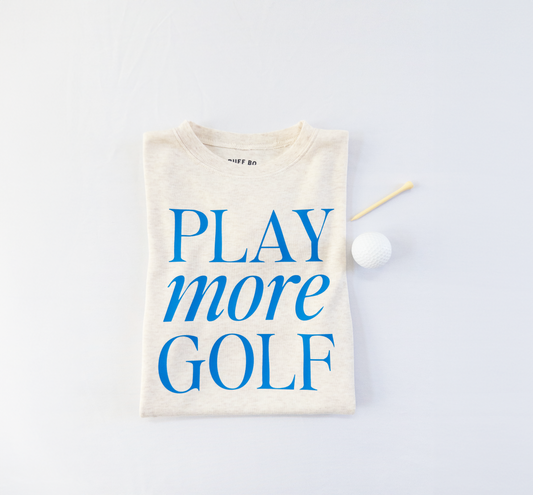 Beige t-shirt with 'PLAY more GOLF' text on a light gray background